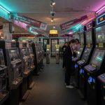 Berlin casino aisle with old mechanical and modern touchscreen slot machines, event banners for