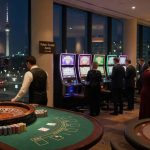 Nighttime photo of a modern Berlin casino floor showing roulette, blackjack, a poker tournament